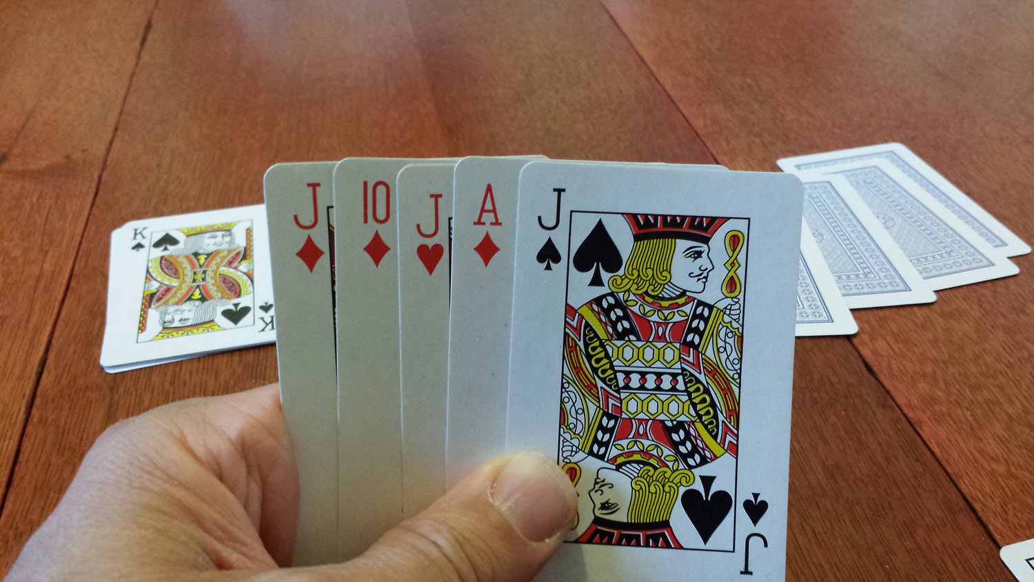 Euchre hand with Jack of Diamonds, 10 of diamonds, Jack of Hearts, Ace of Diamonds, and Jack of Spades.