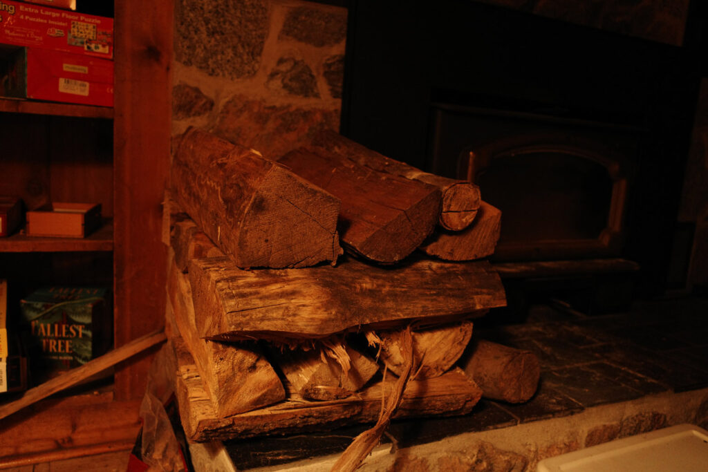 Cut logs near wood fireplace