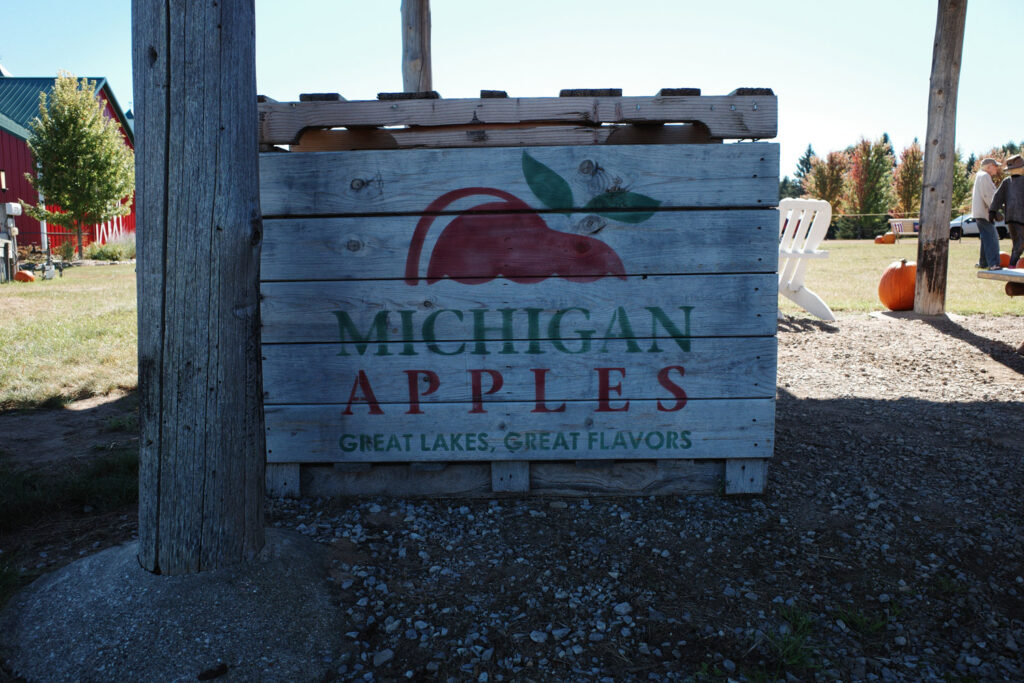 Wooden crate at orchard with text reading "Michigan Apples, Great Lakes, Great Flavors"