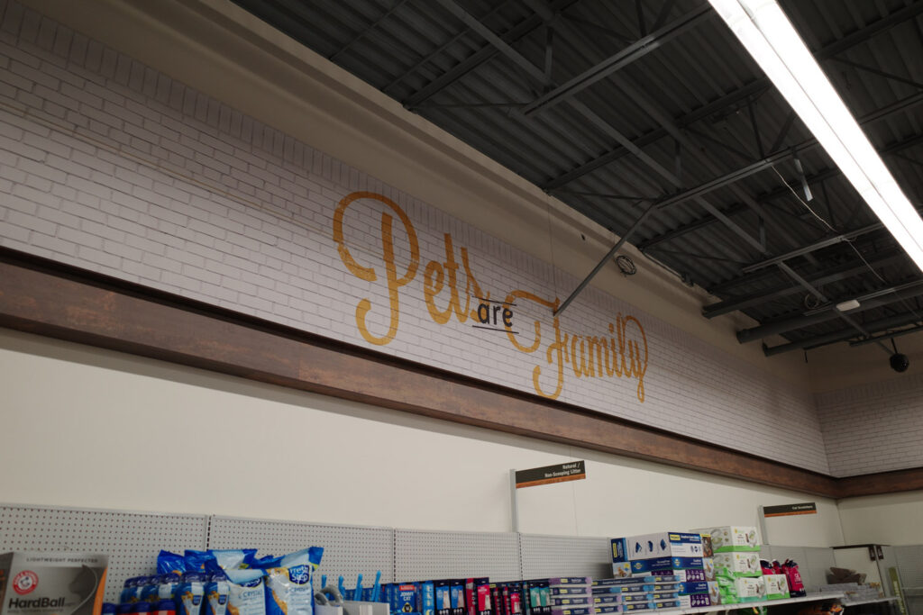 Wall murual saying "pets are family" at Meijer grocery store.