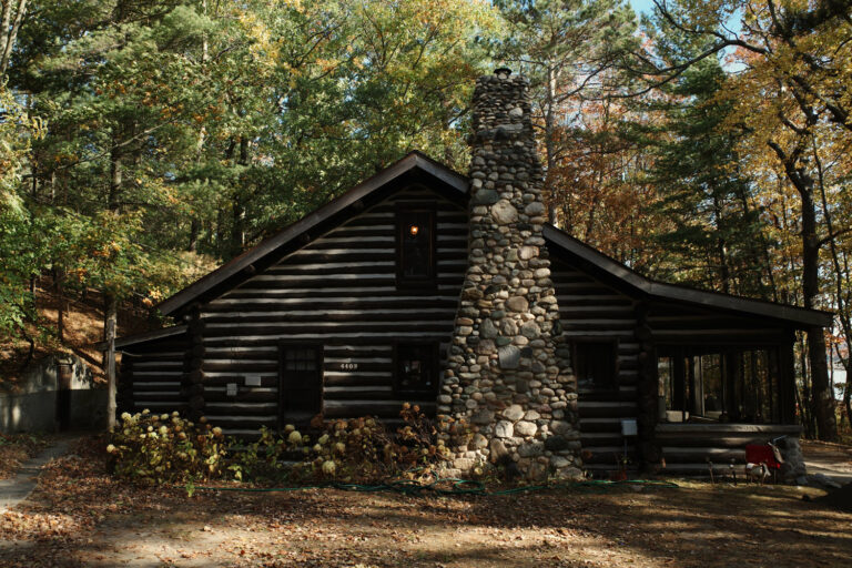 Stone cabin in woods.