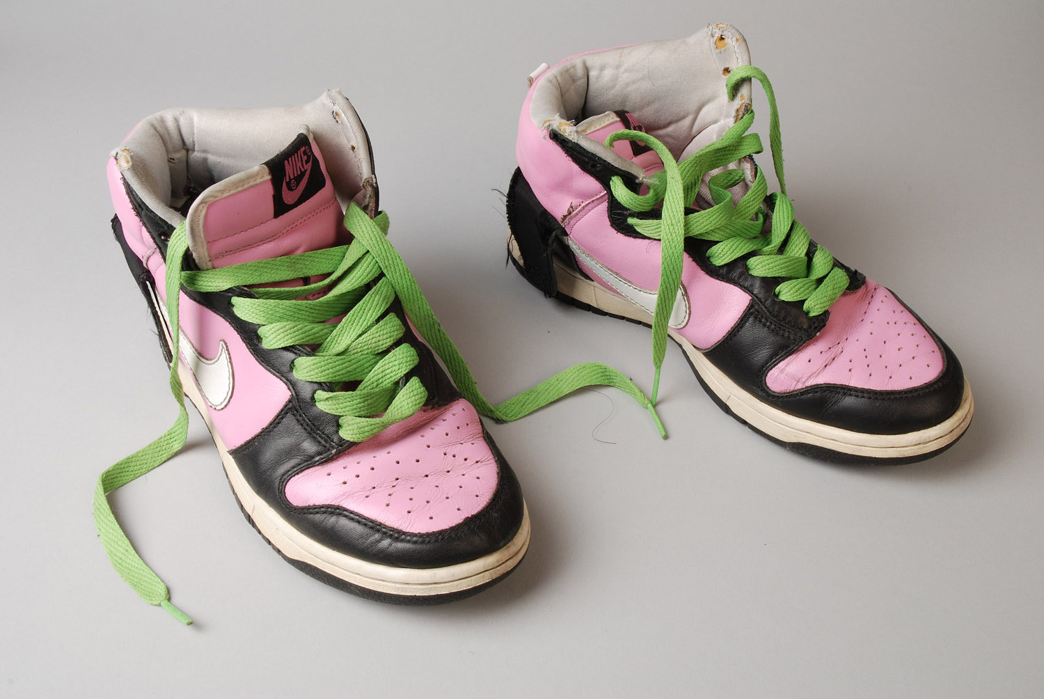 Nike sneakers in pink, black and green.