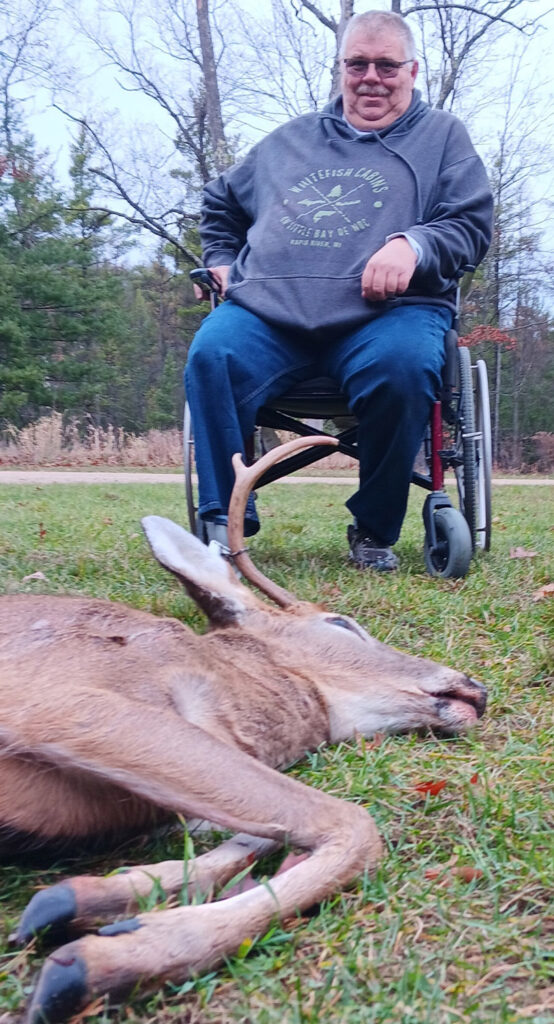 Man in wheelchair with dead buck