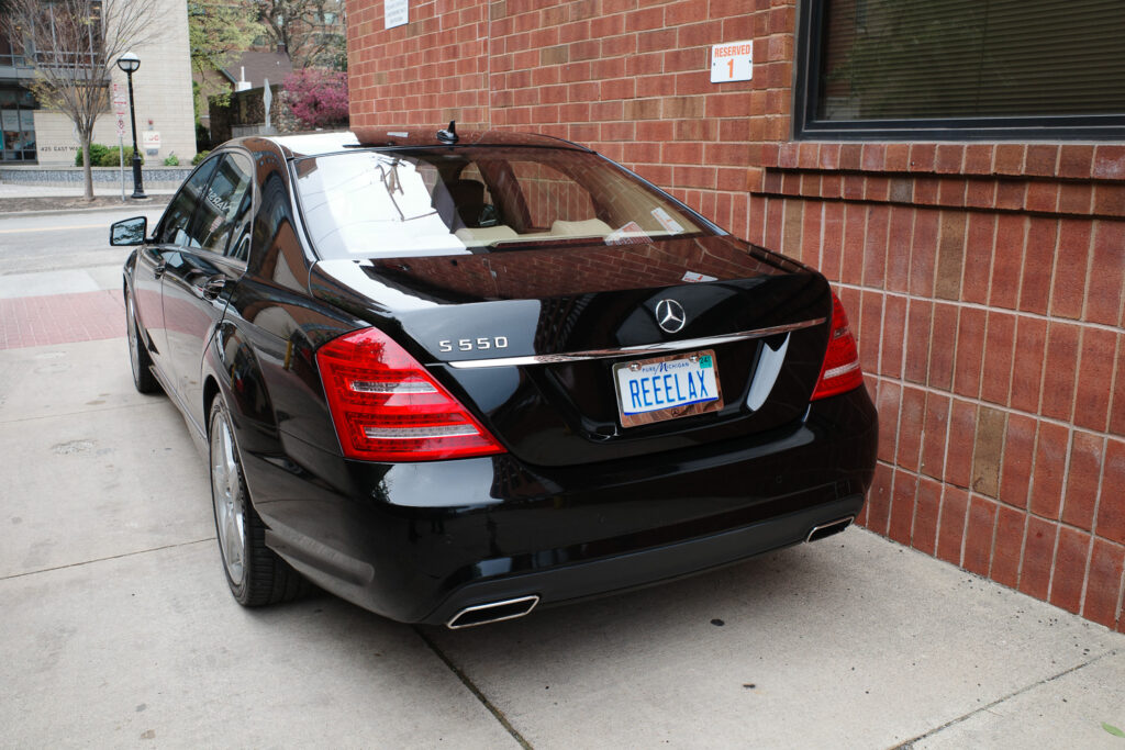 Mercedes S550 with back michigan plate reading "REELAX"