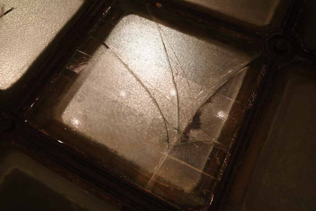 cracked glass panel in rotunda floor with tape over it