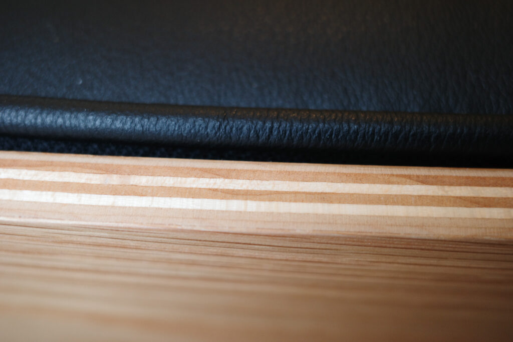 Detail of wood and leather on Eames Lounge chair