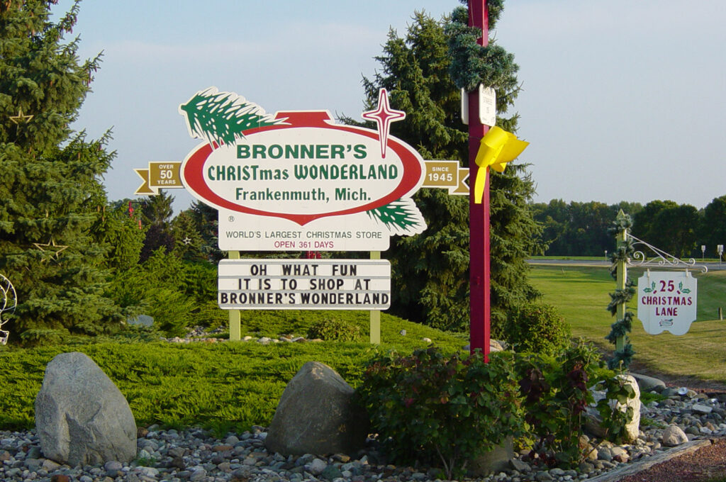 Bronner's sign reading "bronner's christmas wonderland frankenmuth mich since 1945 world's largest christmas store open 361 days oh what fun it is to shop at bronner's wonderland" with address sign reading "25 christmas lane"