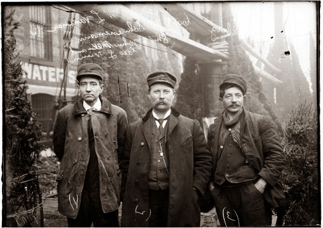 Three men with ships captain in vintage photograph