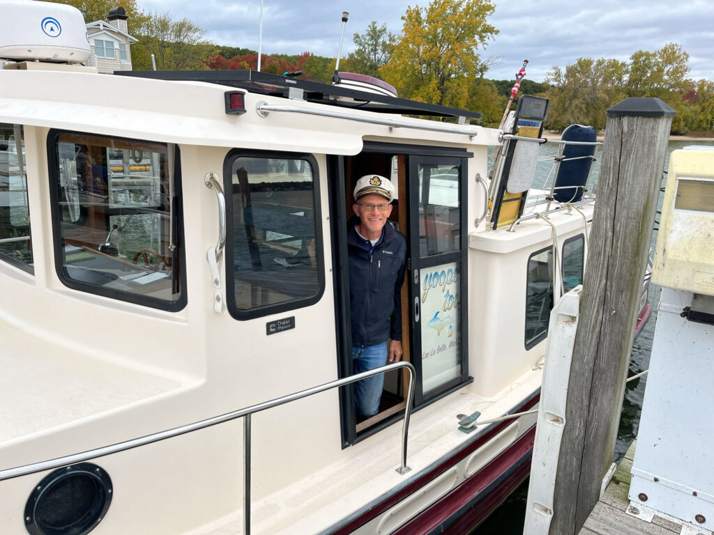 Man in captain's hat on boat.