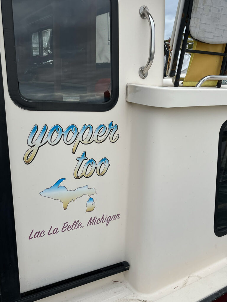 Boat art reading "yooper too, lac la belle, Michigan"