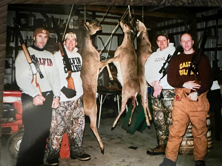 Men with rifles and hunted deer