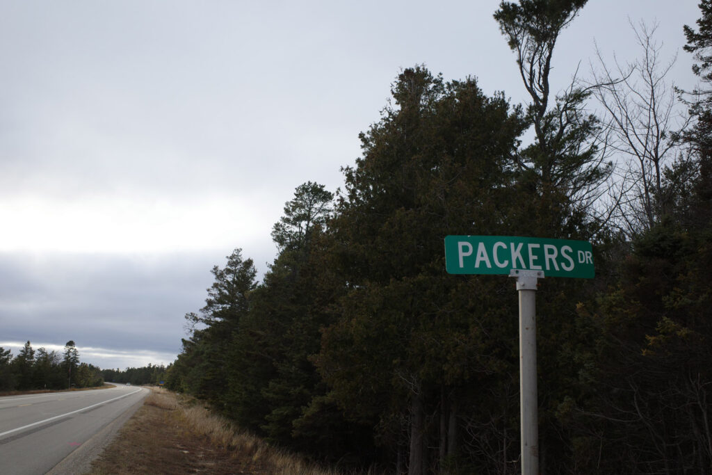 Sign for Packers Drive with forest in background