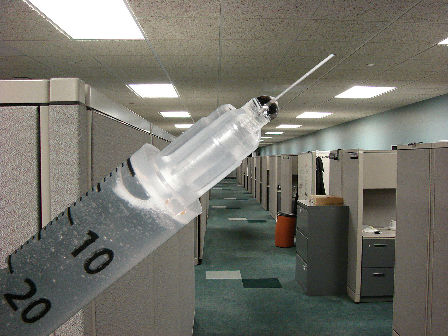 cubicles in office with needle overlaid