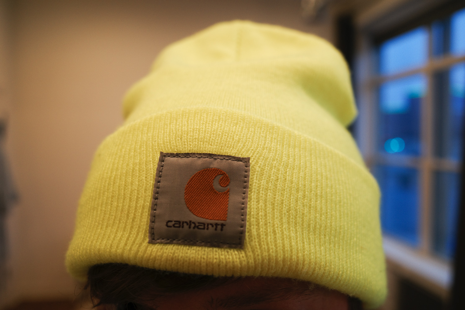 yellow carhartt beanie on man's head