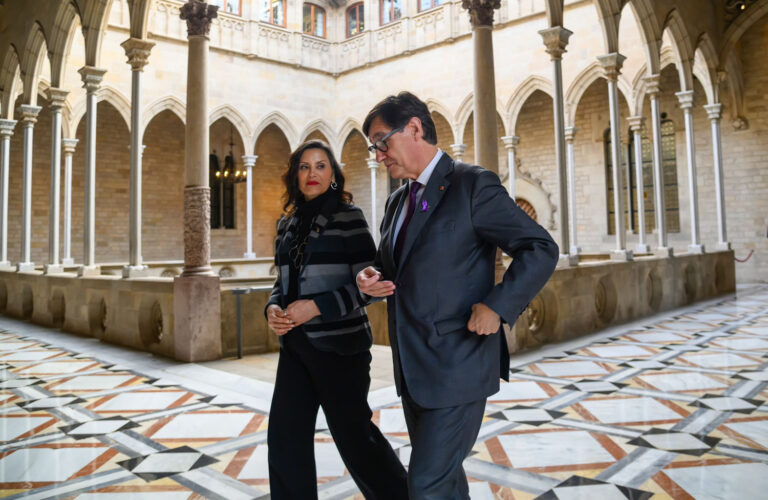 Gretchen Whitmer walking with man in old Spanish building