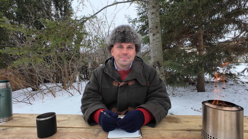 O.W. Root at wooden table outdoors smiling