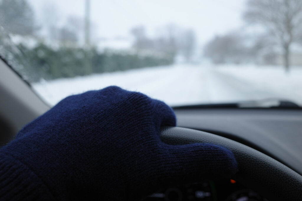 Gloved hand on steering wheel