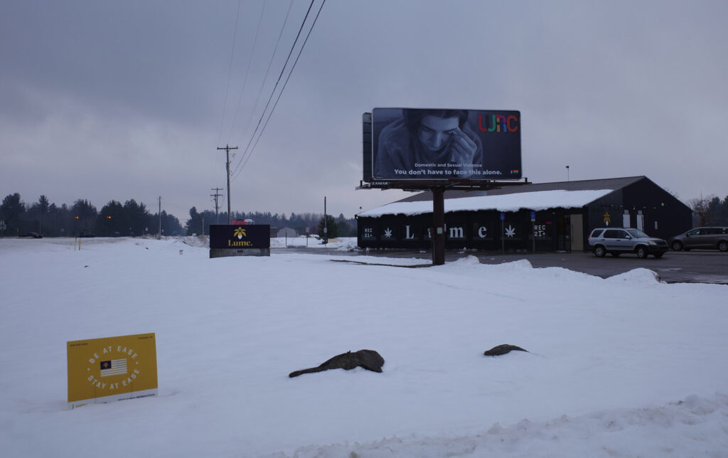 Cannabis storefront with billboard for domestic violence help services