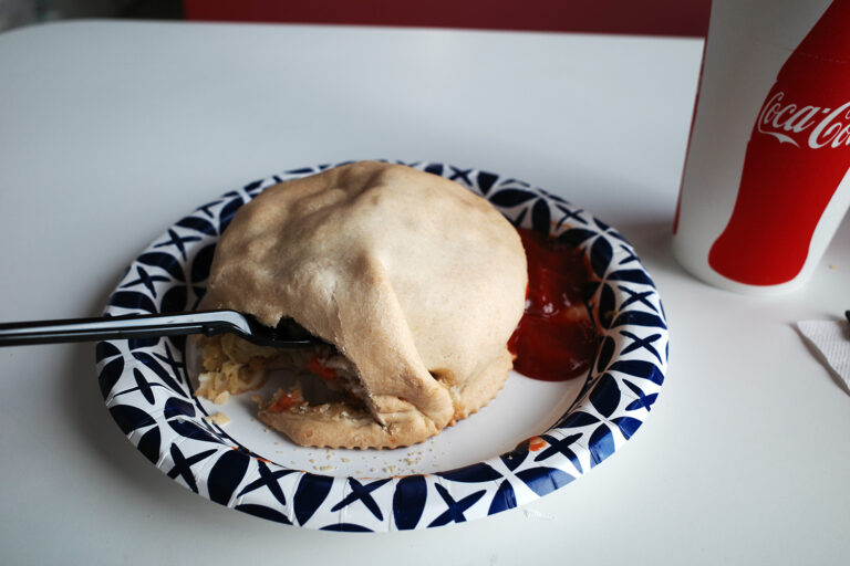 Pastie on plate with fork and coca-cola cup