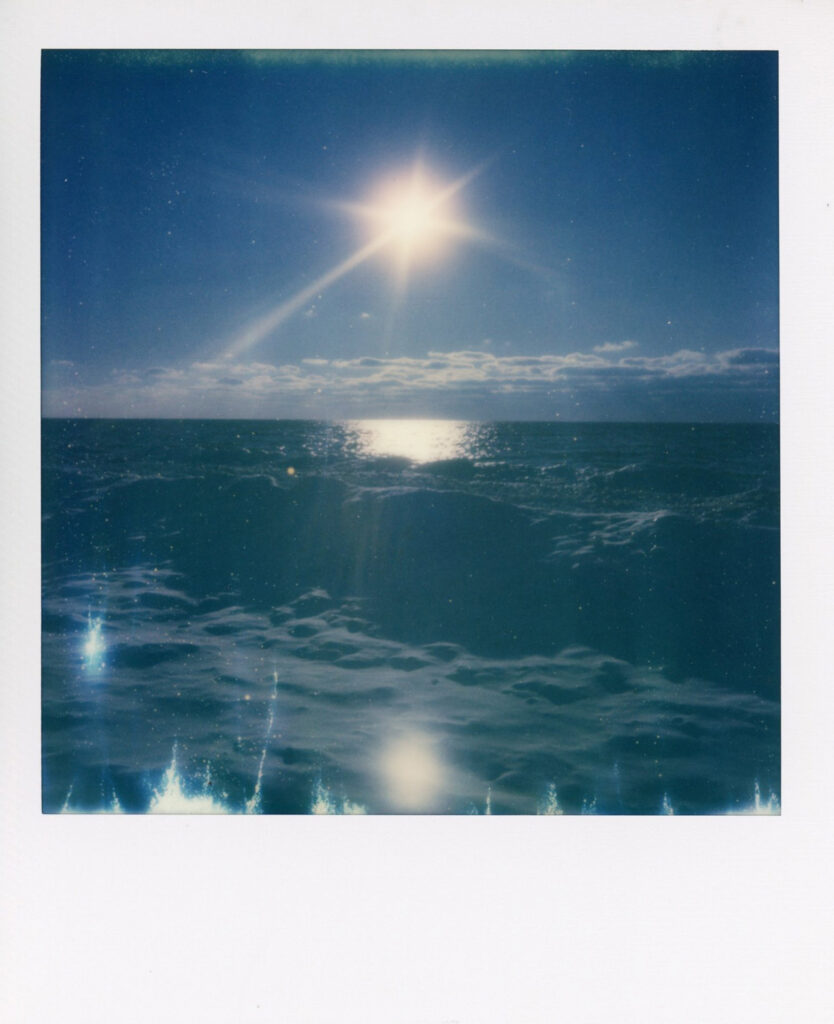 Snow and sun on beach in polaroid scan