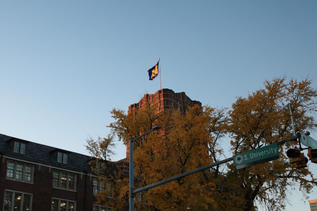 Campus buildings at U-M with Michigan block M flag