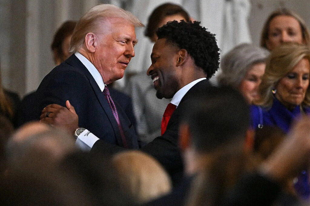 Pastor Lorenzo Sewell shaking hands with President Trump following inauguration