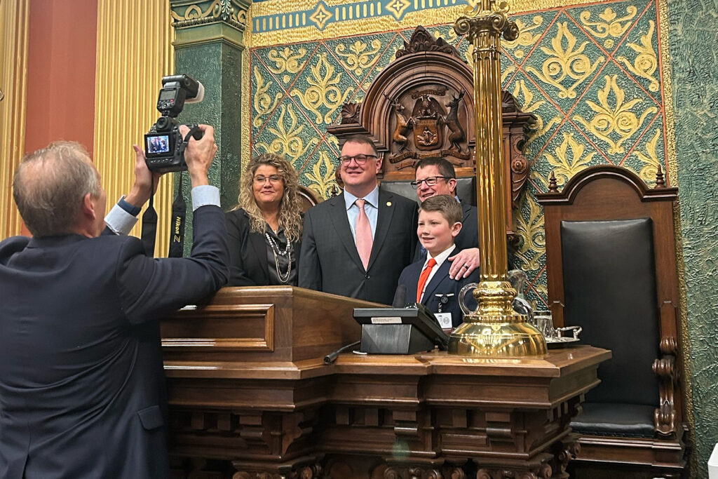 Speaker Mike Hall being photographed at Speaker's podium