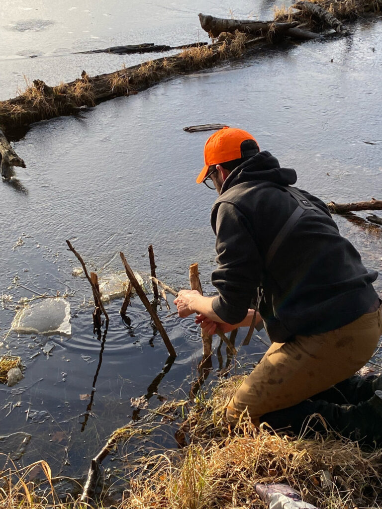 Man setting trap in lake