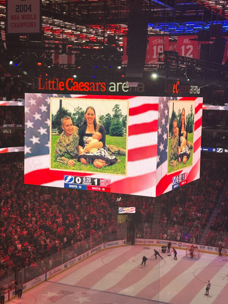 photo of a soldier and his family on jumbotron