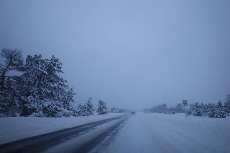 Snowy road with car