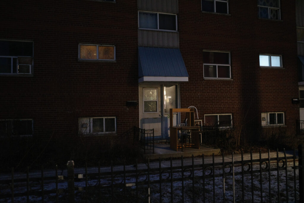 apartment building with boarded up window in windsor