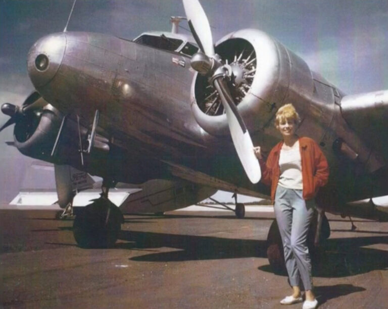 Vintage color photo of woman with silver plane