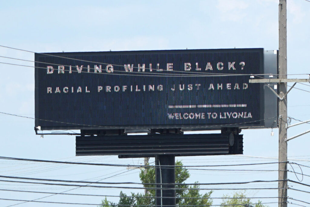 billboard reading "driving while black? racial profiling just ahead. welcome to livonia"