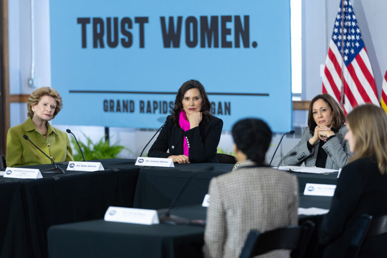 whitmer and kamala at roundtable with "trust women" in background