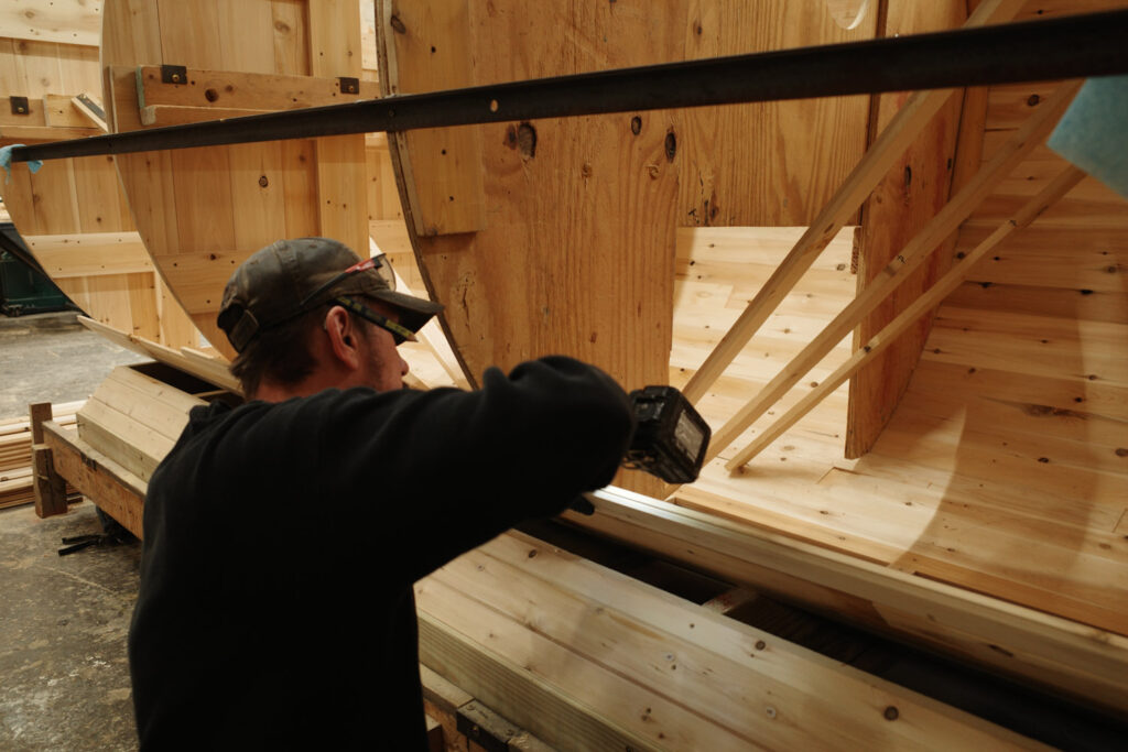 man assembling wood sauna