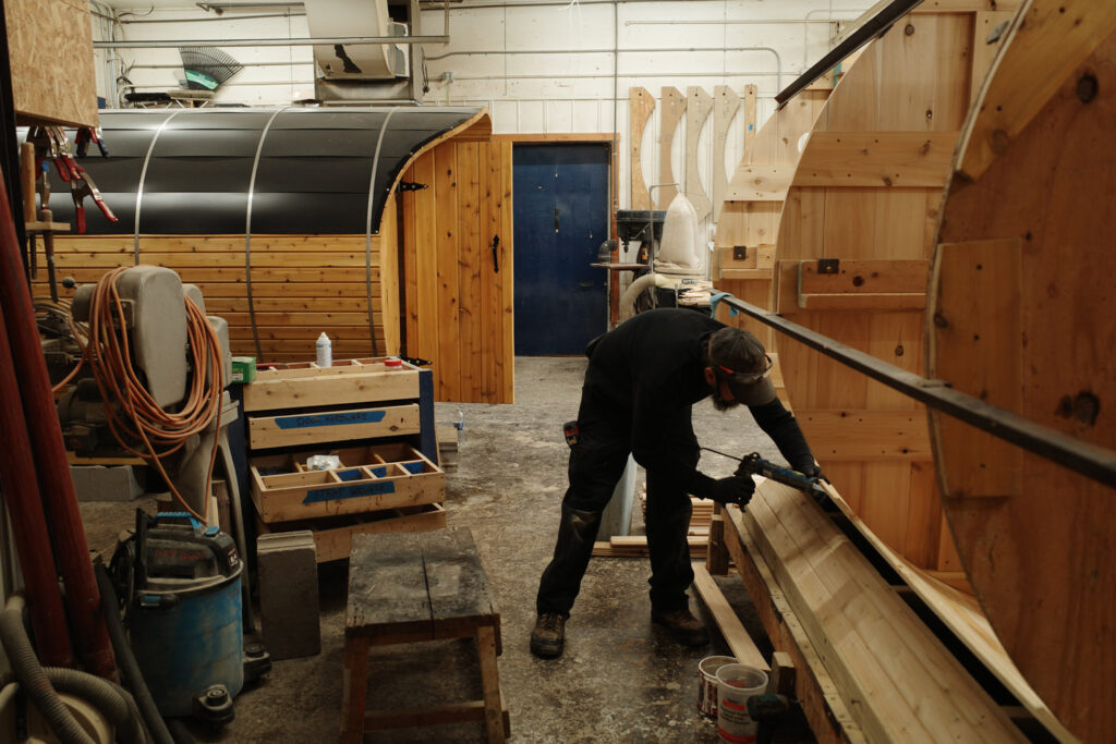 Man drilling wood sauna together