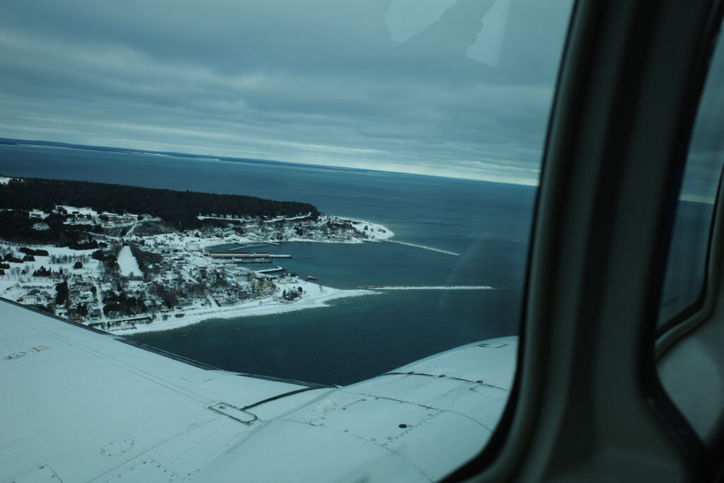 View of snow and island out plane window