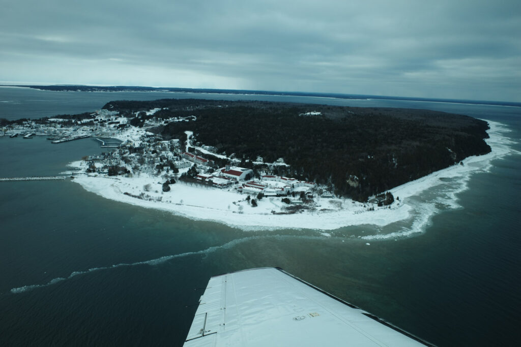 View of snow and island out plane window