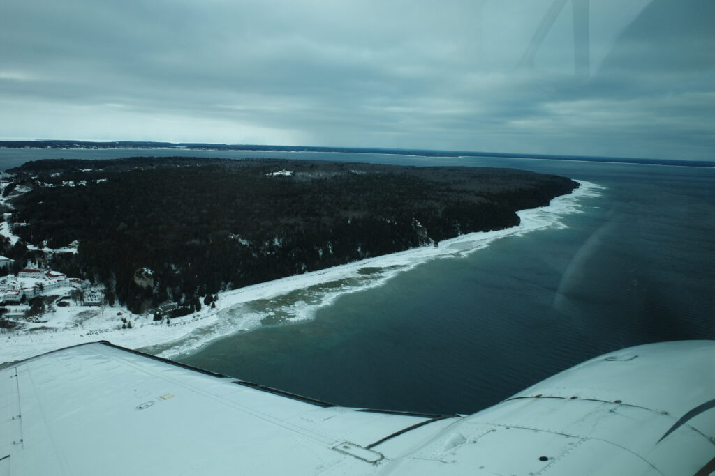 View of snow and island out plane window