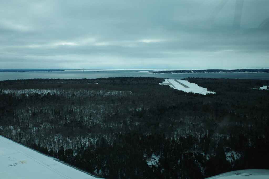 View of snow and island airport out plane window