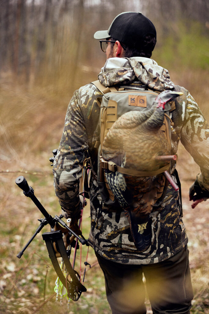 James carrying bow with dead bird on back