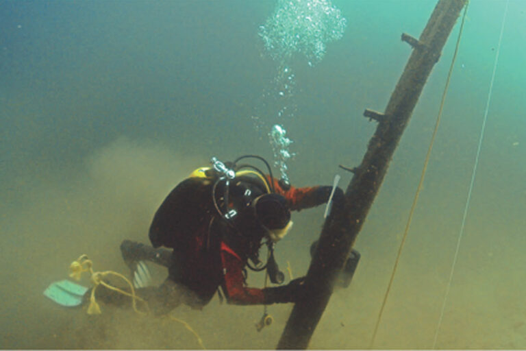 scuba diver recovering part of ship