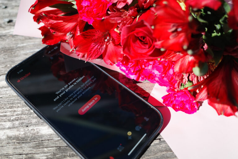 flowers next to dating app on phone