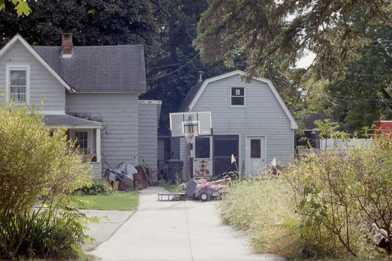 old home with basketball hoop