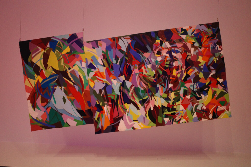 paintings hanging by wire at angle
