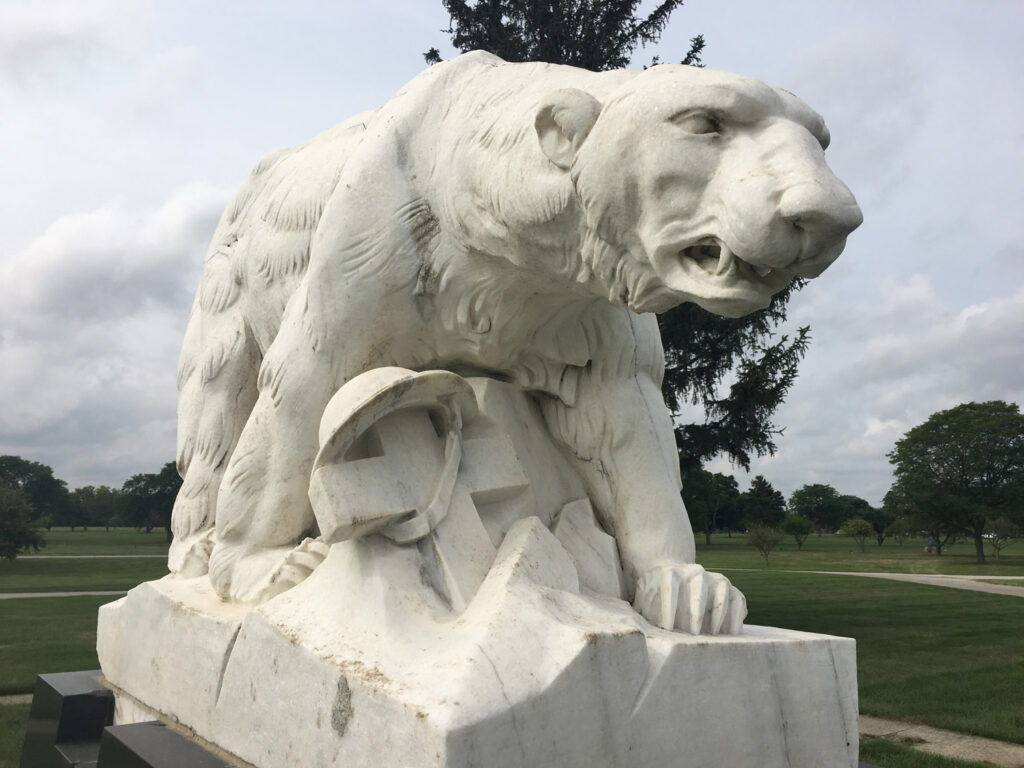 polar bear statue with cross and helmet