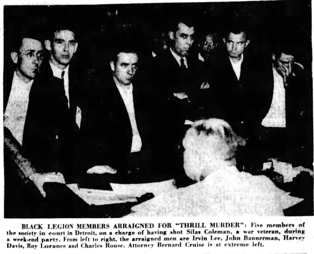 black legion member arraignment with caption reading "BLACK LEGION MEMBERS ARRAIGNED FOR "THRILL MURDER": Five members of the society in court in Detroit, on a charge of having shot Silas Coleman, • war veteran, during a weekend party. From left to right, the arraigned men are Irvin Lee, John Bannerman, Harvey Davis, Roy Lorance and Charles Rouse. Attorney Bernard Cruise is at extreme left."
