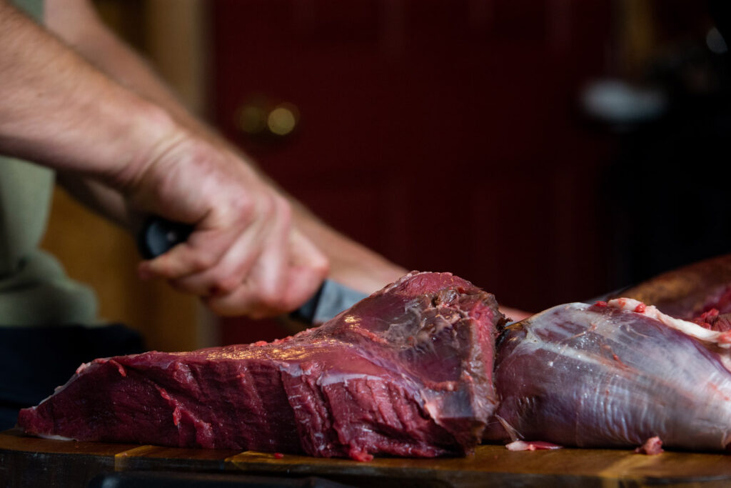 man cutting meat