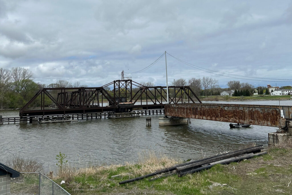 rusted train bridge over river
