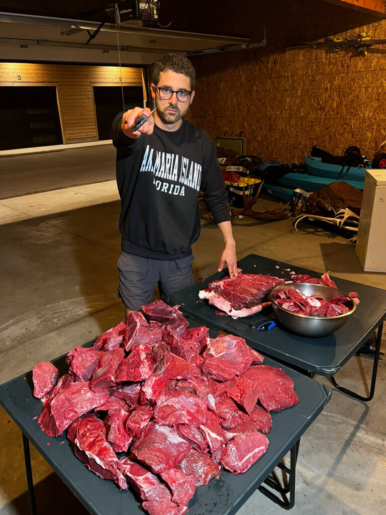 man with table full of meat